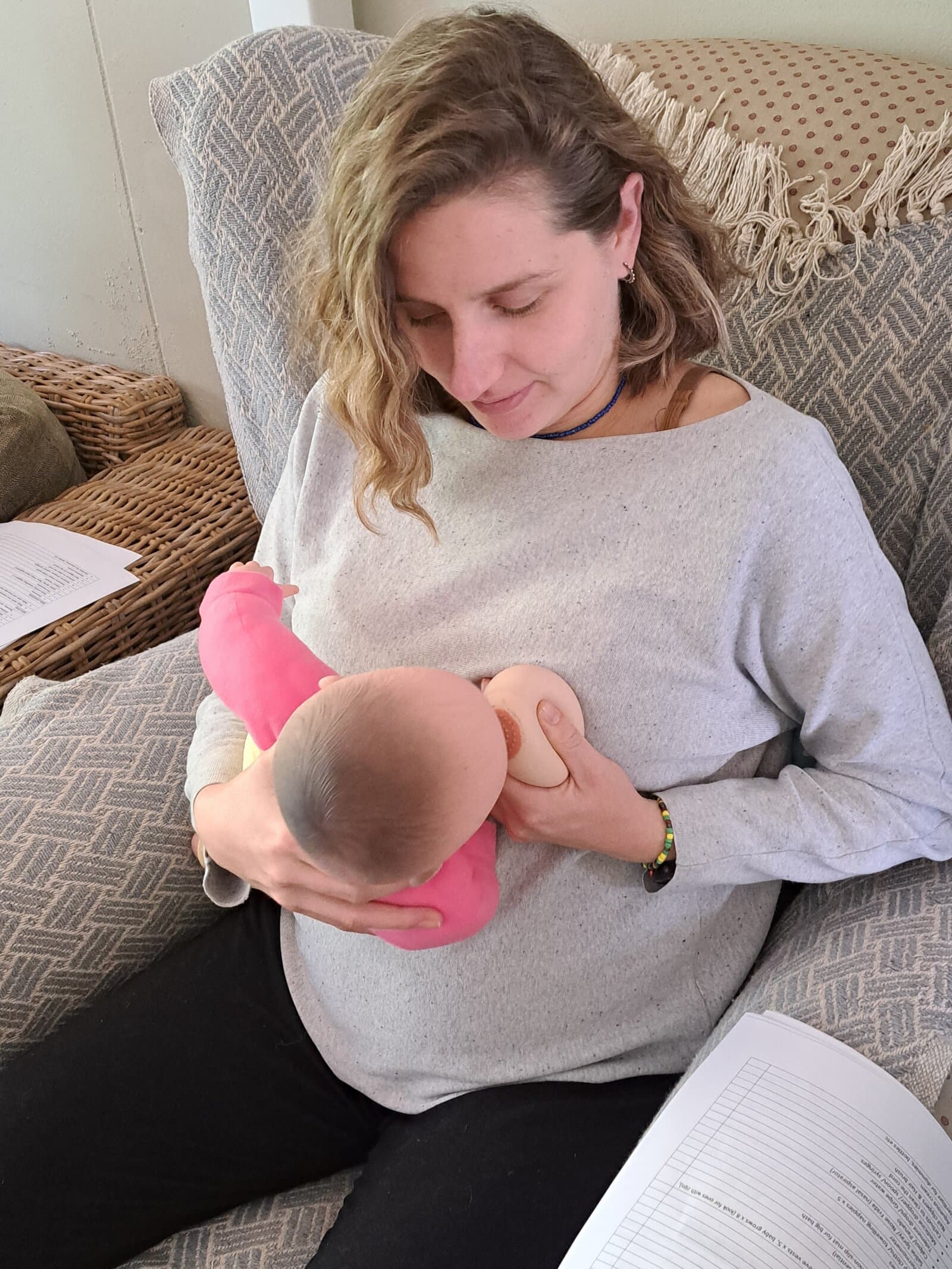 Young mum breastfeeding her baby on the couch