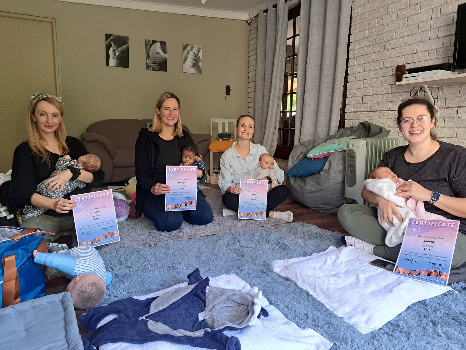 Mums with certificates after completing the baby massage course