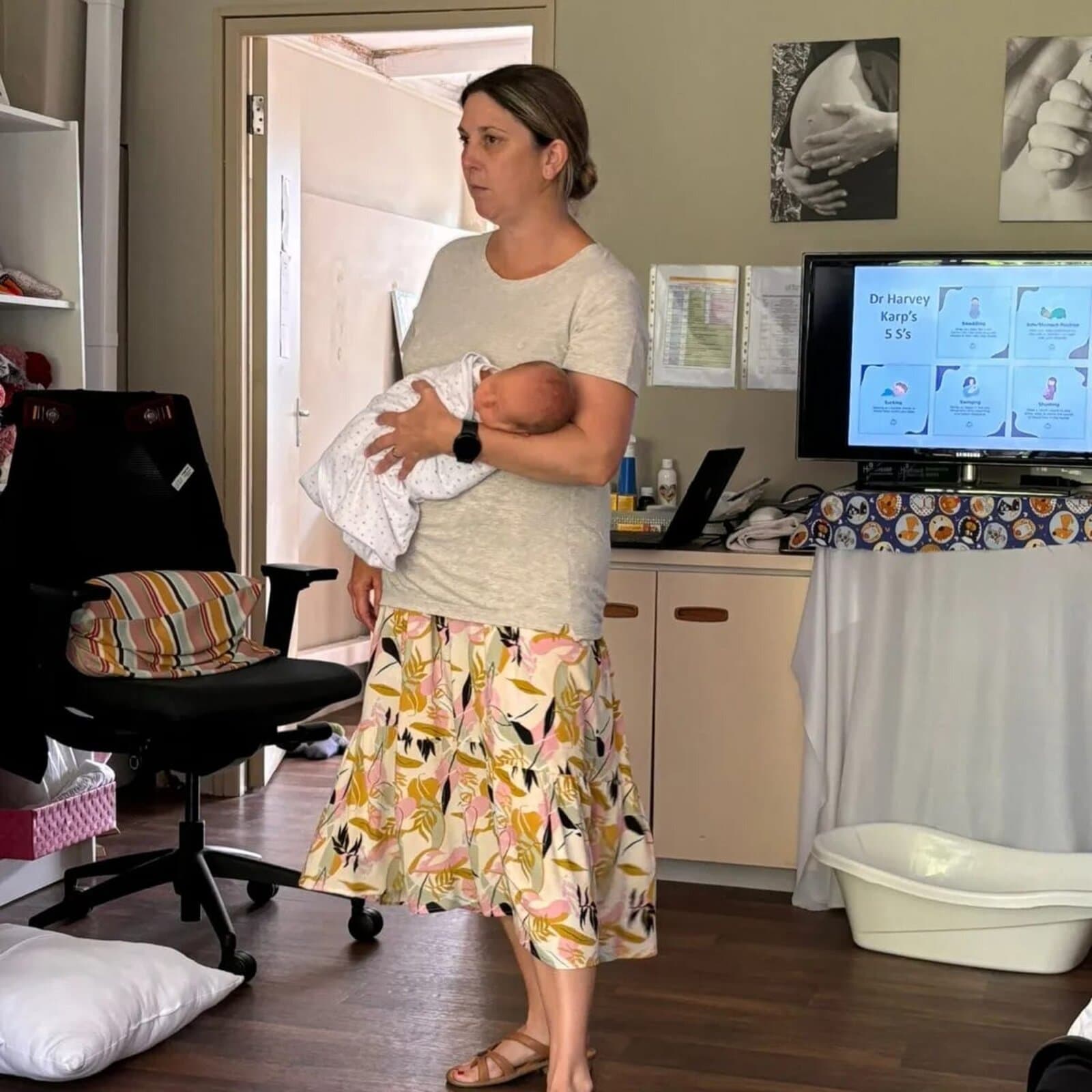 Megan demonstrating newborn soothing techniques during a class