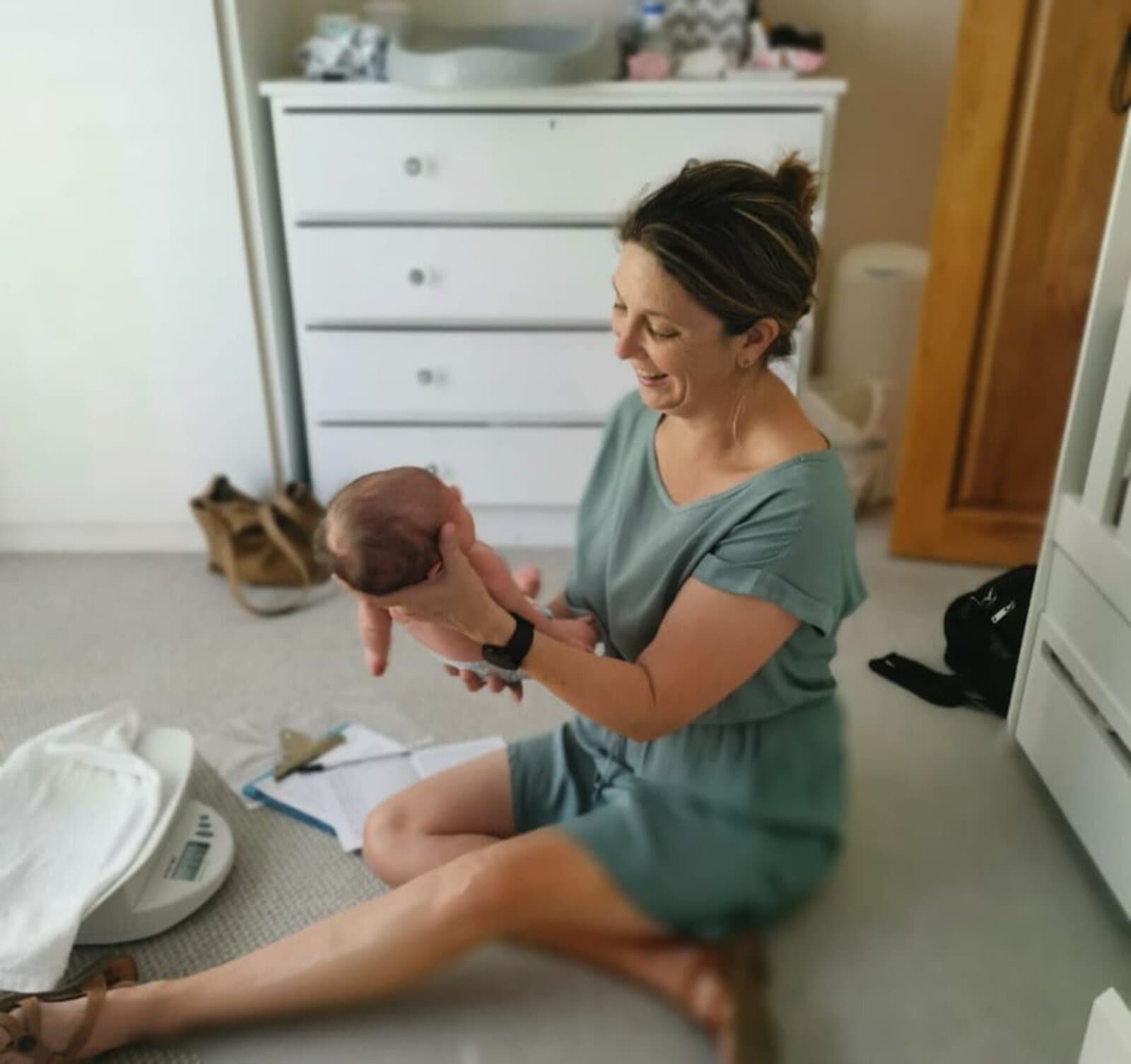 Megan on a postnatal home visit with a newborn on a scale