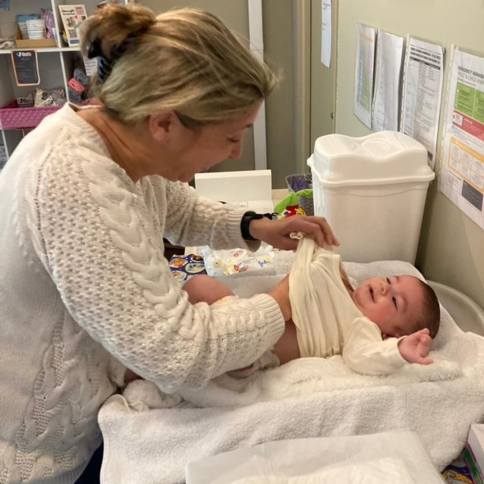 Megan examining a baby during a well-baby check